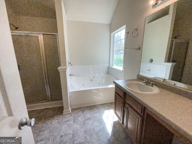 bathroom with vanity, shower with separate bathtub, and vaulted ceiling