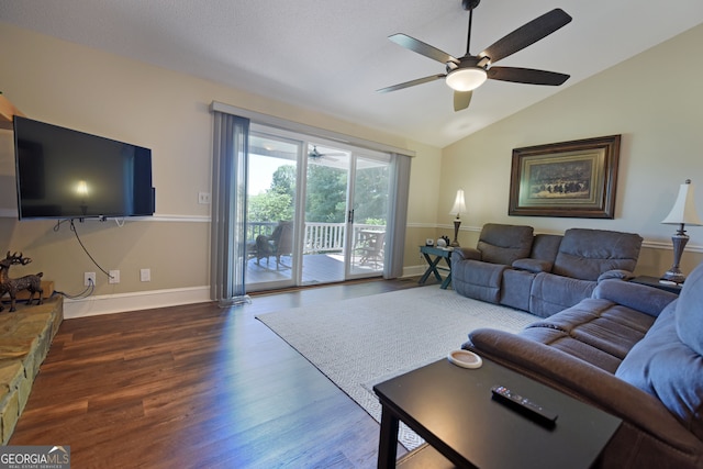 living room with dark hardwood / wood-style flooring, vaulted ceiling, and ceiling fan