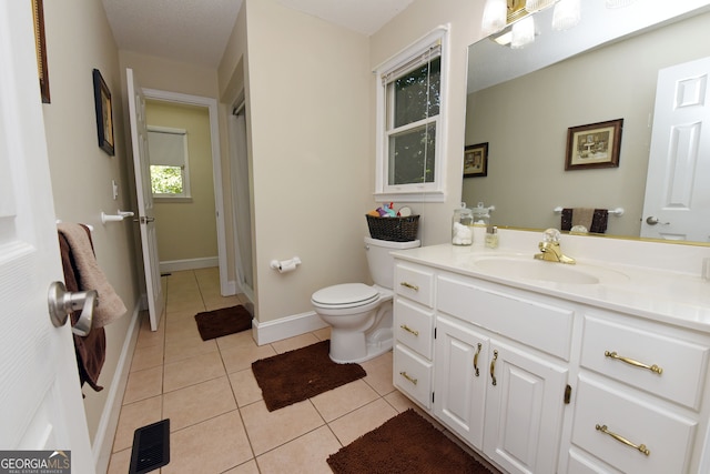 bathroom featuring tile patterned flooring, vanity, and toilet