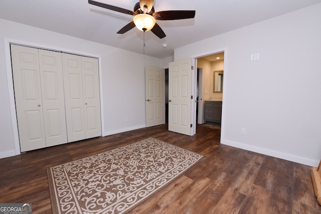 unfurnished bedroom with ceiling fan, dark hardwood / wood-style floors, a textured ceiling, and a closet