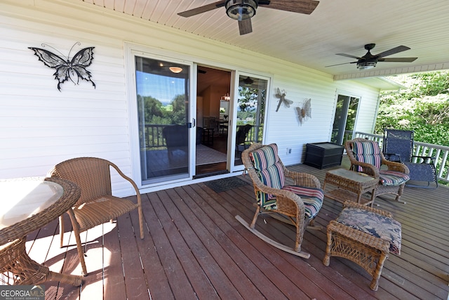 wooden deck featuring ceiling fan