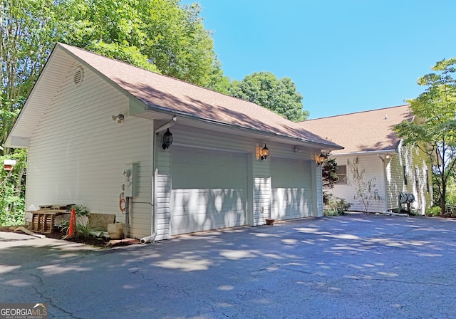 view of side of property with an outbuilding and a garage