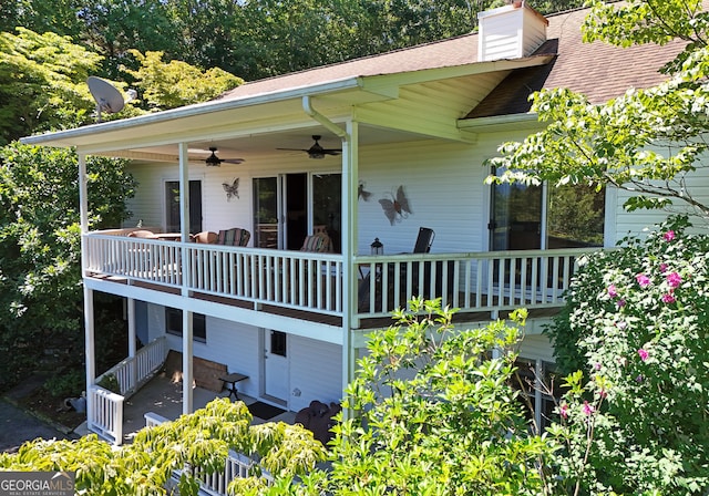 rear view of property with ceiling fan