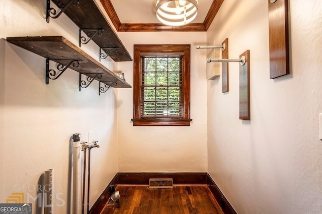 doorway to outside with wood-type flooring and ornamental molding