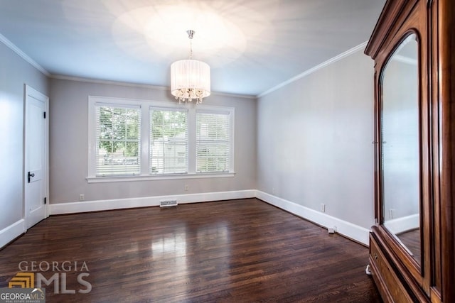 unfurnished room featuring dark wood-type flooring, an inviting chandelier, and crown molding