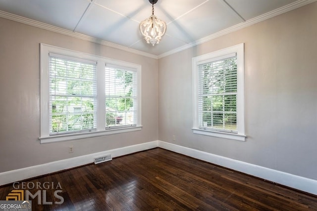 unfurnished room featuring a wealth of natural light, hardwood / wood-style floors, and an inviting chandelier