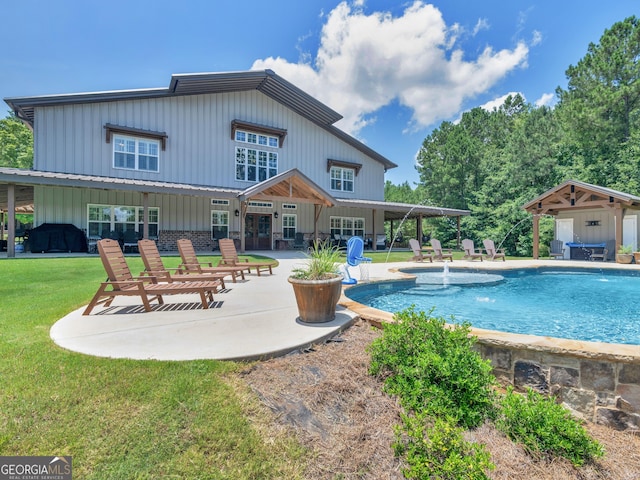 view of pool with a grill, pool water feature, a yard, and a patio area