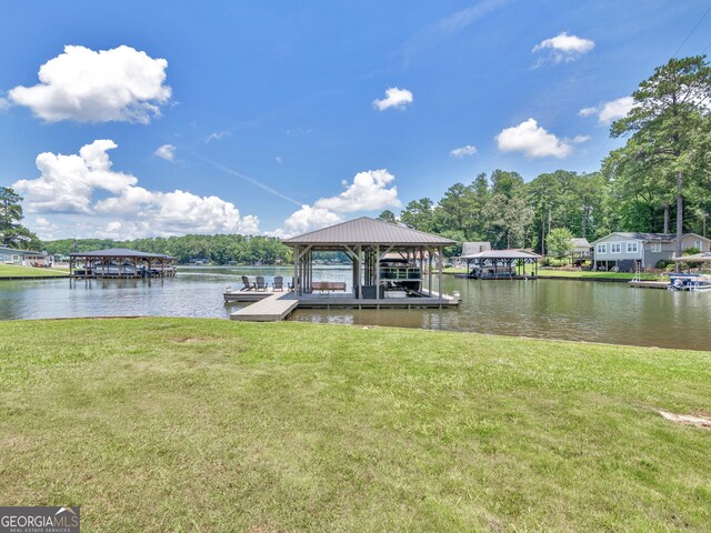 dock area featuring a water view and a yard