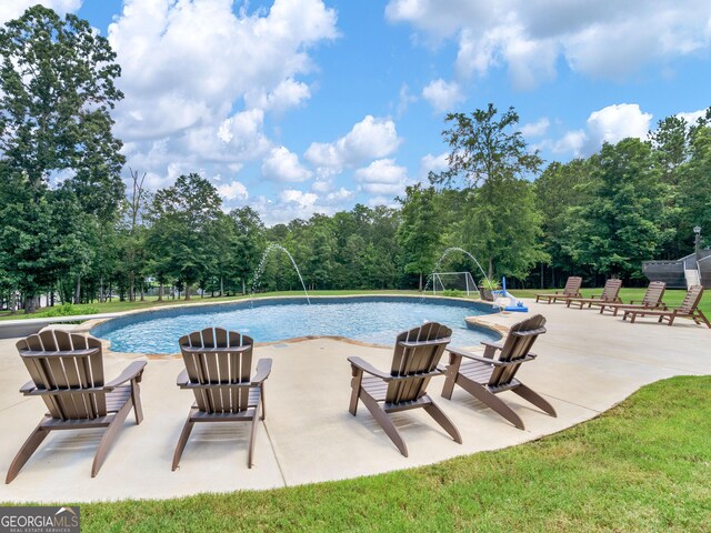 view of pool with a patio and pool water feature