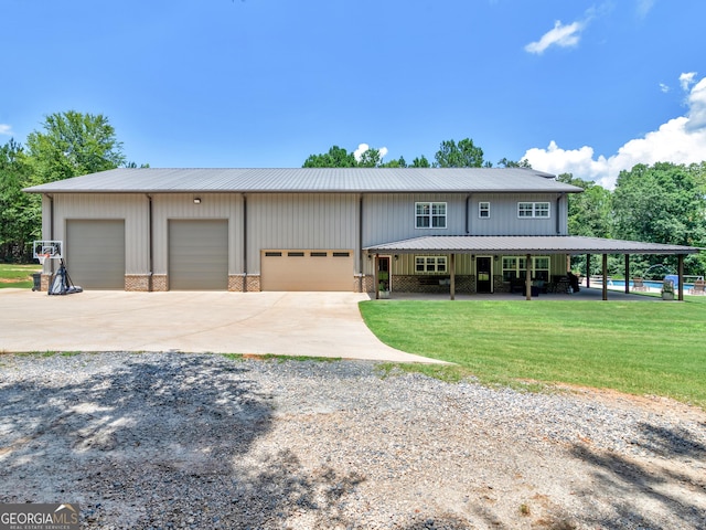 view of front of property featuring a garage and a front lawn