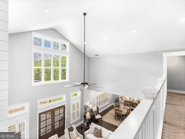 interior space featuring french doors, carpet, and high vaulted ceiling