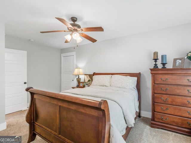 bedroom featuring light colored carpet and ceiling fan