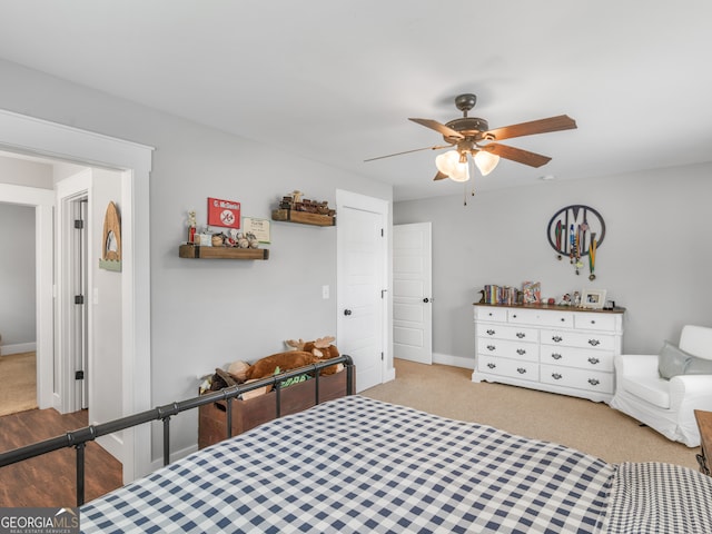 bedroom featuring light carpet and ceiling fan