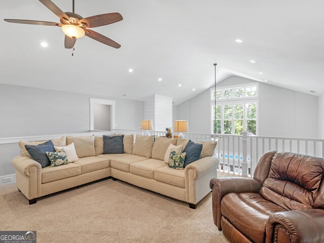 carpeted living room with ceiling fan and lofted ceiling