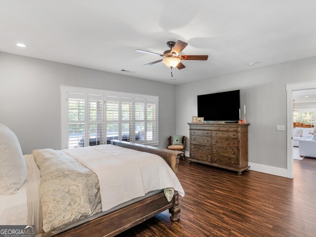 bedroom with dark hardwood / wood-style floors and ceiling fan