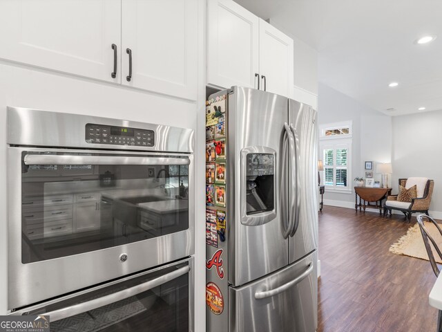 kitchen with white cabinetry, dark hardwood / wood-style floors, and appliances with stainless steel finishes