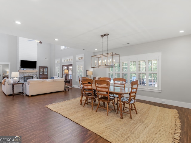 dining area featuring dark wood-type flooring and a notable chandelier