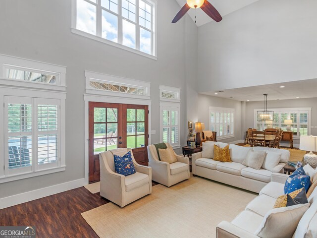 living room featuring a healthy amount of sunlight, hardwood / wood-style floors, and a high ceiling