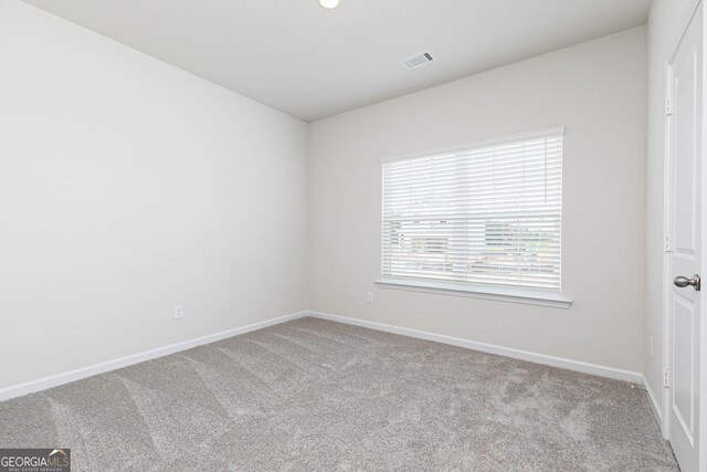 spare room with light colored carpet