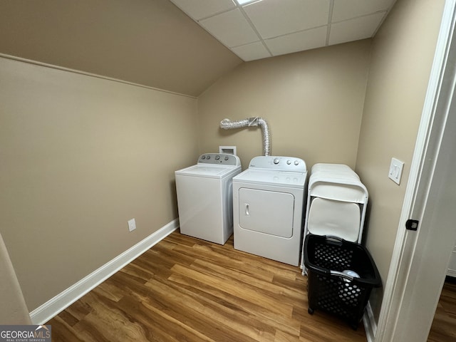 laundry room with washing machine and dryer, hookup for a washing machine, and hardwood / wood-style flooring