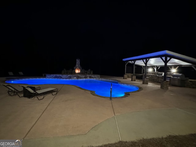 pool at night with a patio