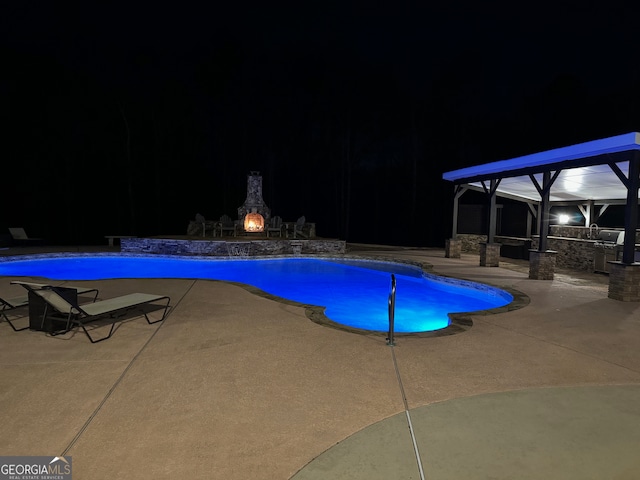 pool at night with a patio