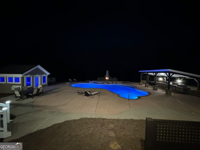 pool at twilight with a patio