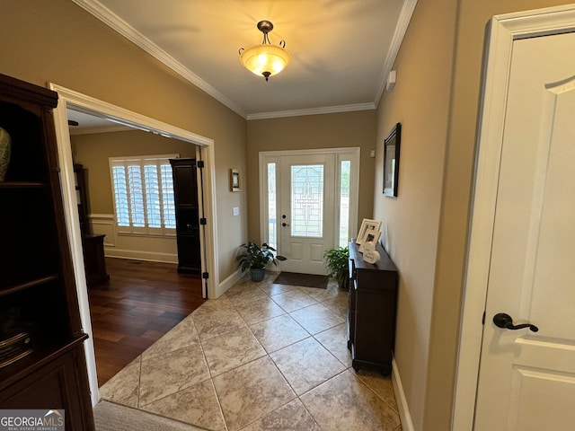 foyer with tile floors and ornamental molding