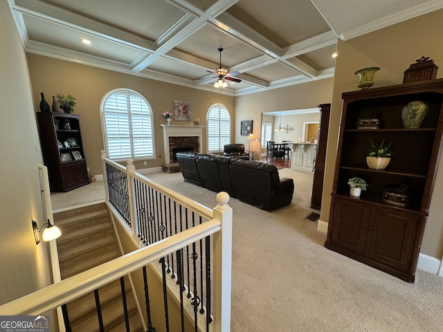 hallway with beamed ceiling, crown molding, coffered ceiling, and carpet