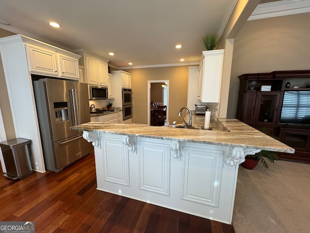 kitchen with crown molding, stainless steel appliances, kitchen peninsula, and white cabinets