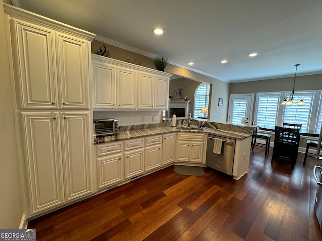 kitchen with dark hardwood / wood-style flooring, kitchen peninsula, dishwasher, tasteful backsplash, and sink