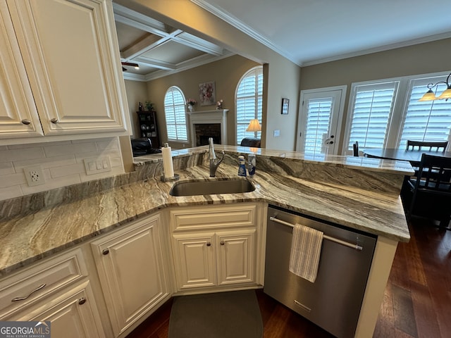 kitchen with dark hardwood / wood-style floors, light stone countertops, stainless steel dishwasher, a brick fireplace, and coffered ceiling