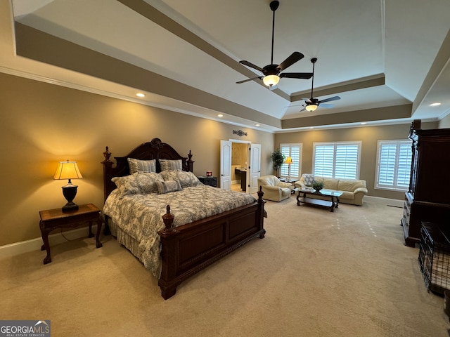 bedroom featuring ceiling fan, a tray ceiling, crown molding, and light carpet