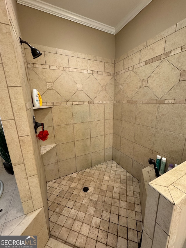 bathroom featuring a tile shower and ornamental molding