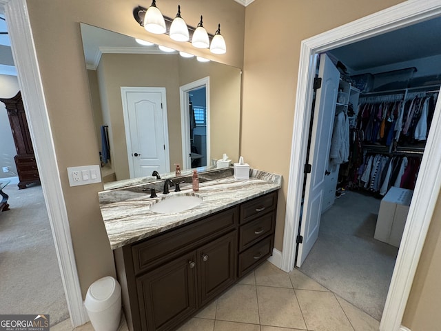 bathroom featuring tile floors, ornamental molding, and oversized vanity