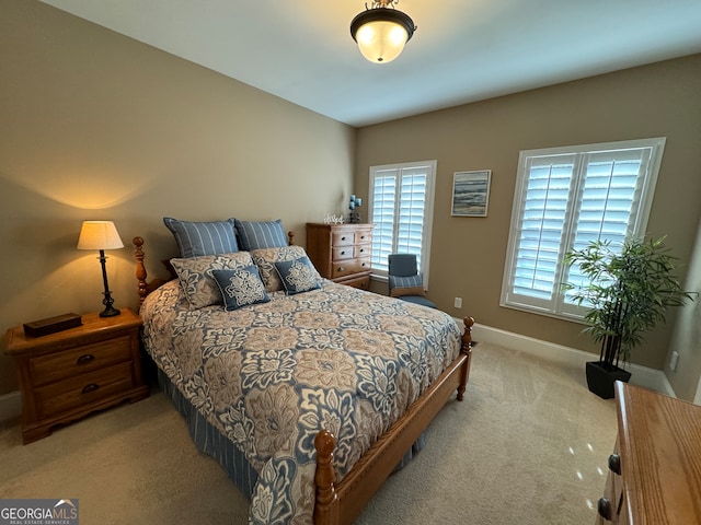 carpeted bedroom featuring multiple windows