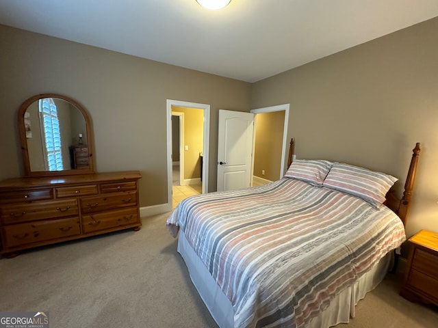 carpeted bedroom with connected bathroom