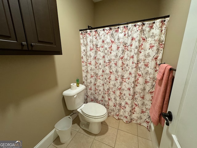 bathroom with tile floors and toilet