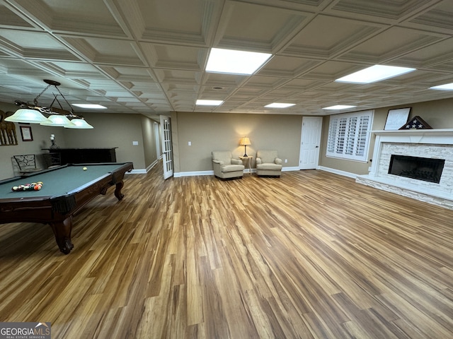 playroom with a stone fireplace, billiards, and hardwood / wood-style flooring