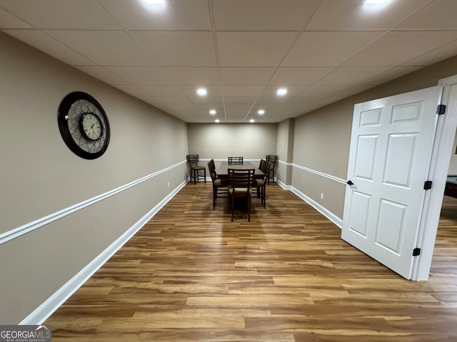 dining area featuring hardwood / wood-style flooring and a drop ceiling