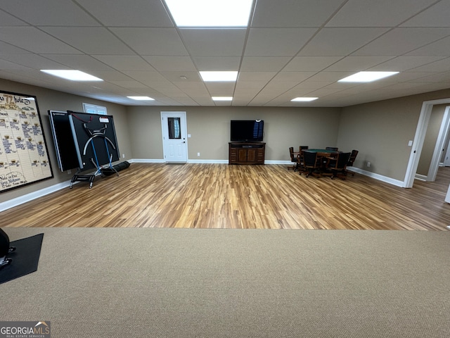 interior space featuring a drop ceiling and wood-type flooring