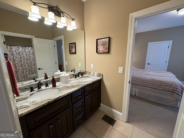 bathroom with tile flooring and dual vanity