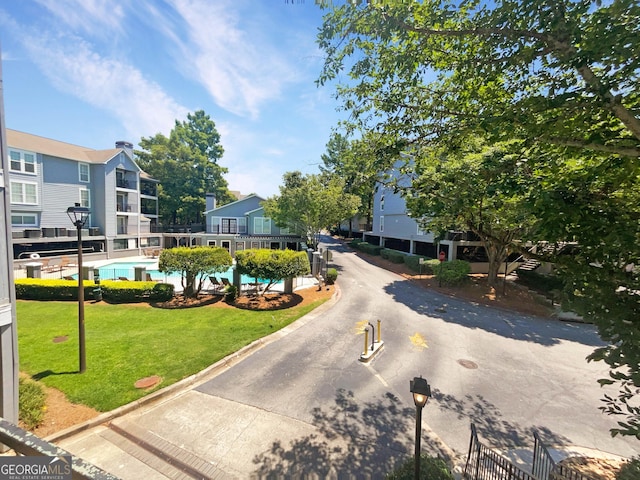 view of community with a pool and a lawn