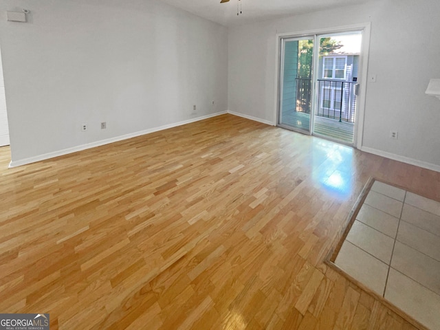 empty room with light hardwood / wood-style flooring and ceiling fan