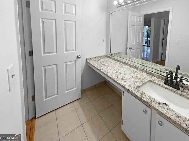 bathroom with tile patterned flooring and vanity