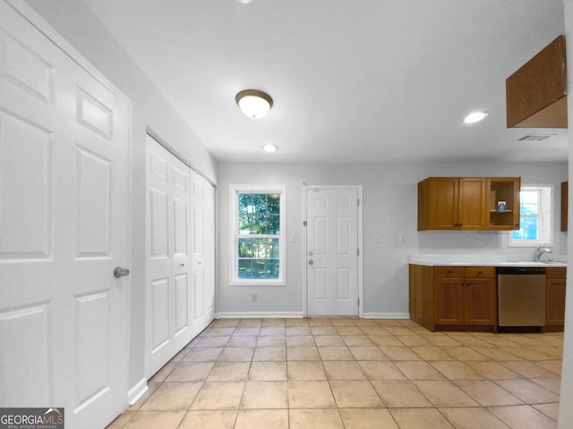 kitchen featuring dishwasher, light tile patterned floors, and sink