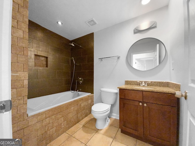 full bathroom featuring tile patterned floors, vanity, tiled shower / bath combo, and toilet