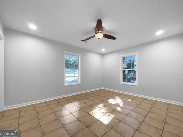 unfurnished room featuring ceiling fan and light tile patterned floors