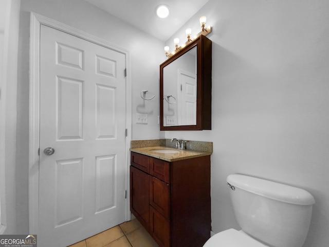 bathroom with tile patterned flooring, vanity, and toilet