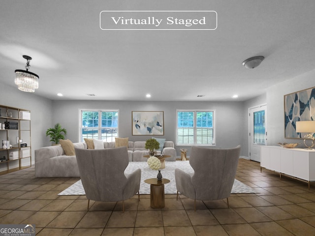 living room featuring dark tile patterned floors, a wealth of natural light, and a notable chandelier